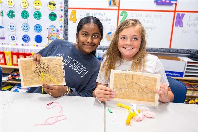 Students learning about embroidery